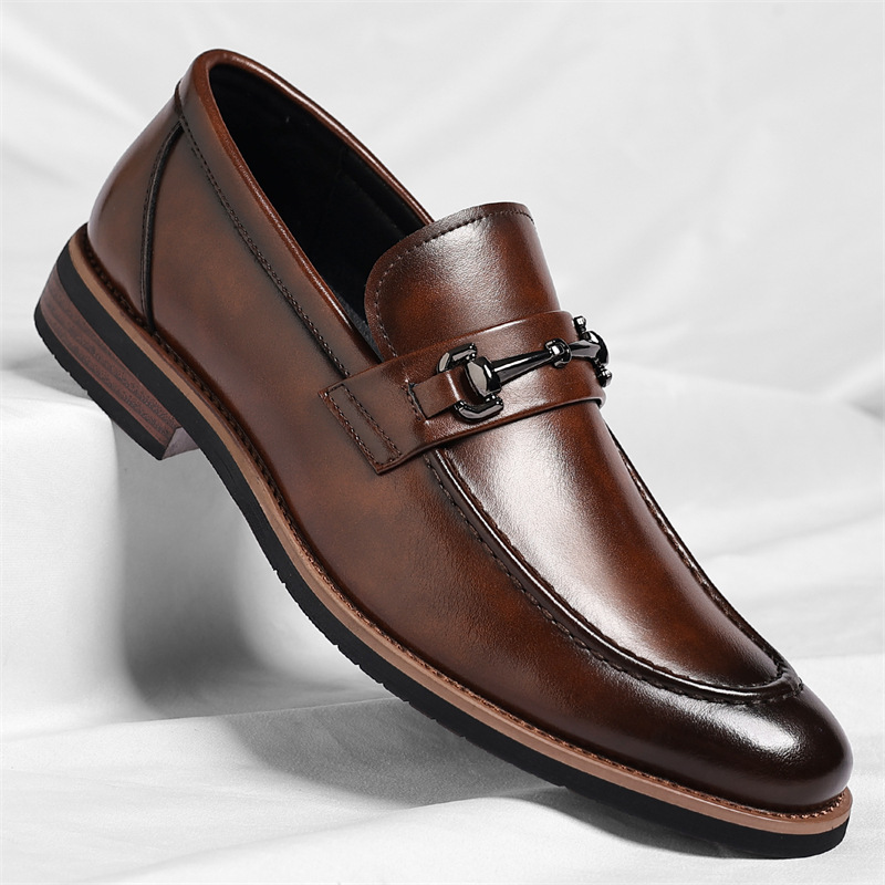 Tan leather loafer featuring stitched apron toe and metal snaffle trim