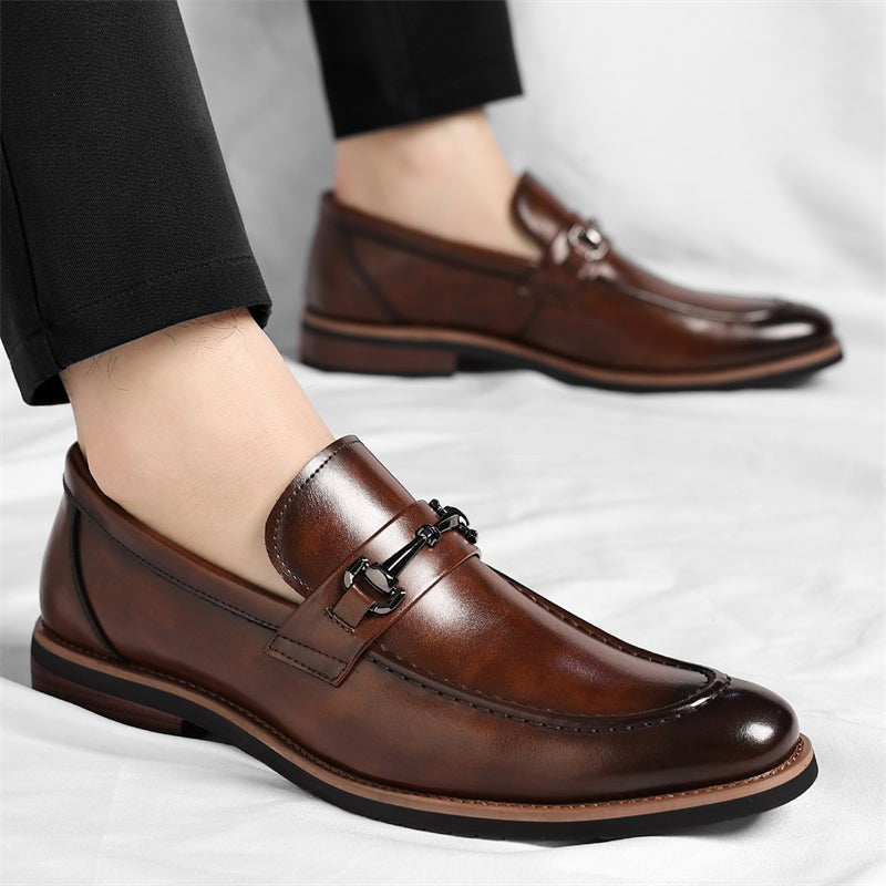 Model wearing brown leather loafers paired with tailored black trousers