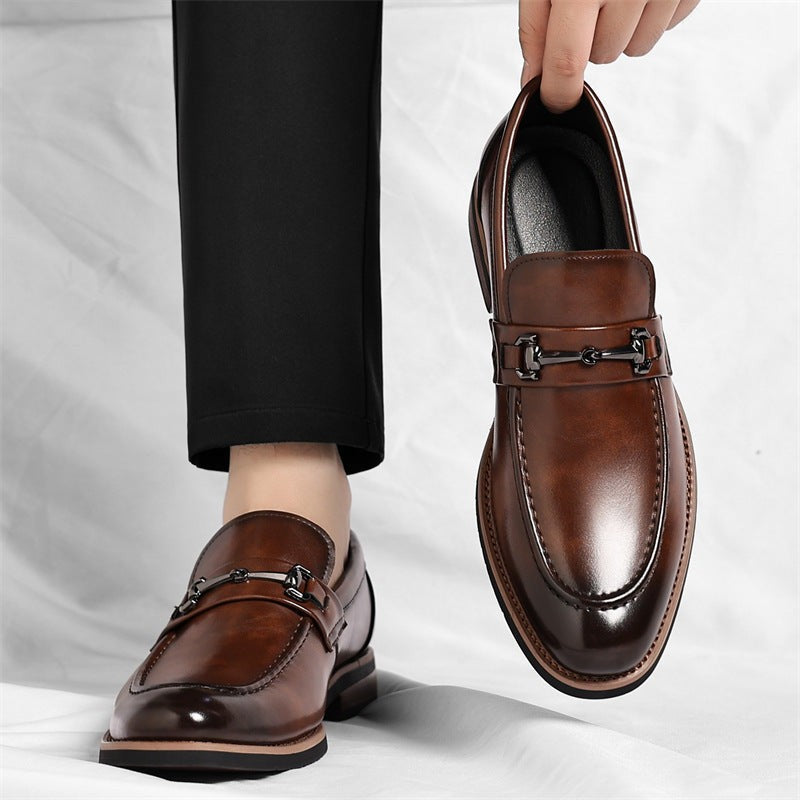 Side view of brown leather loafers worn with cropped black trousers