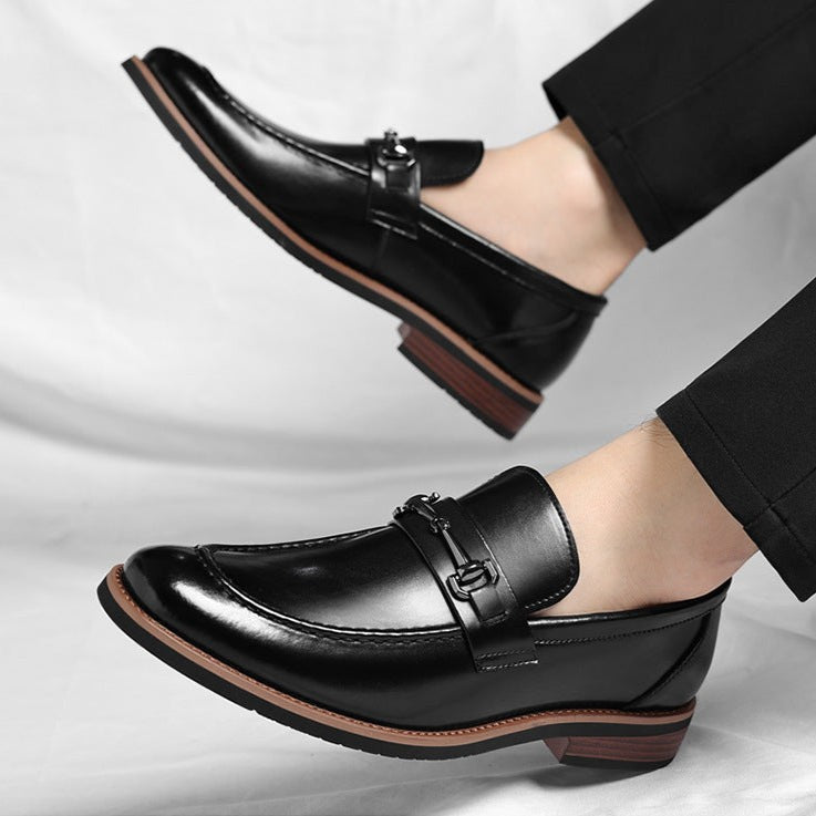 Black leather loafers worn with black trousers, polished horsebit buckle