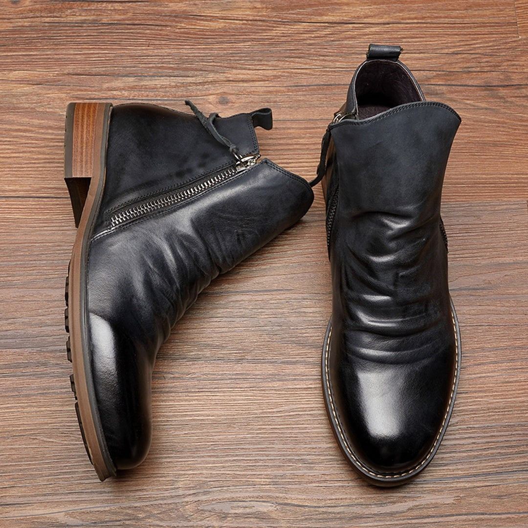 Black leather ankle boots with ruched detail and side zip fastening