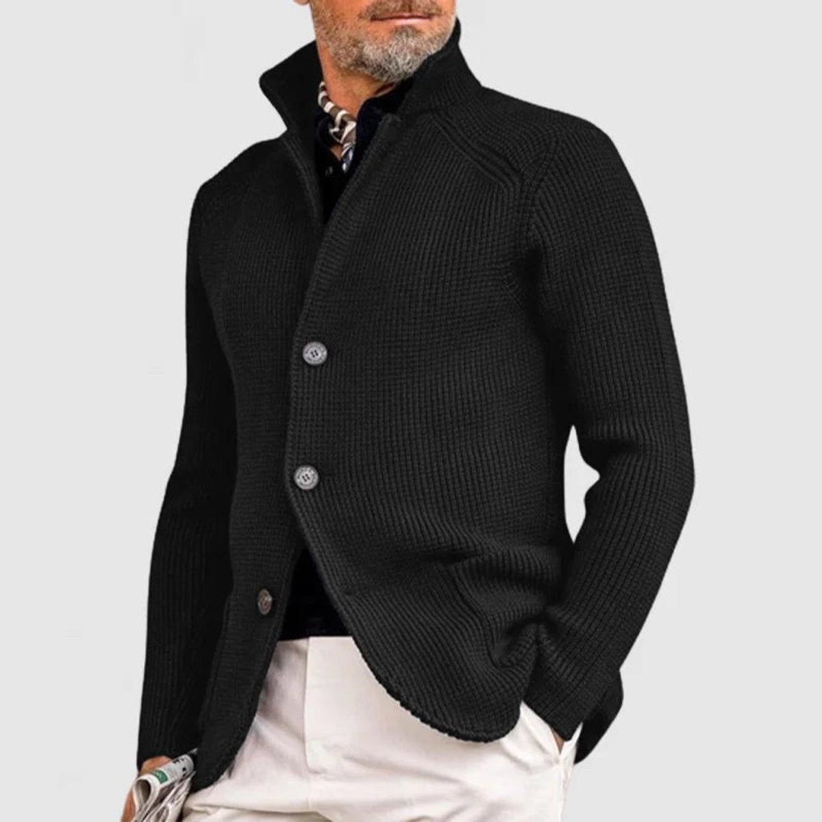 Black ribbed knit button-front cardigan worn with white trousers