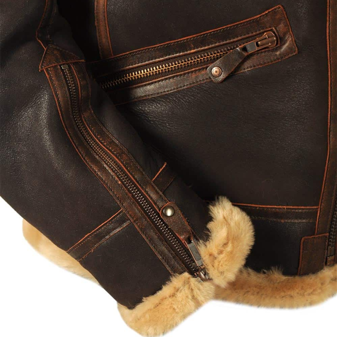 Close-up of cuff zip and fur trim on brown leather pilot jacket sleeve