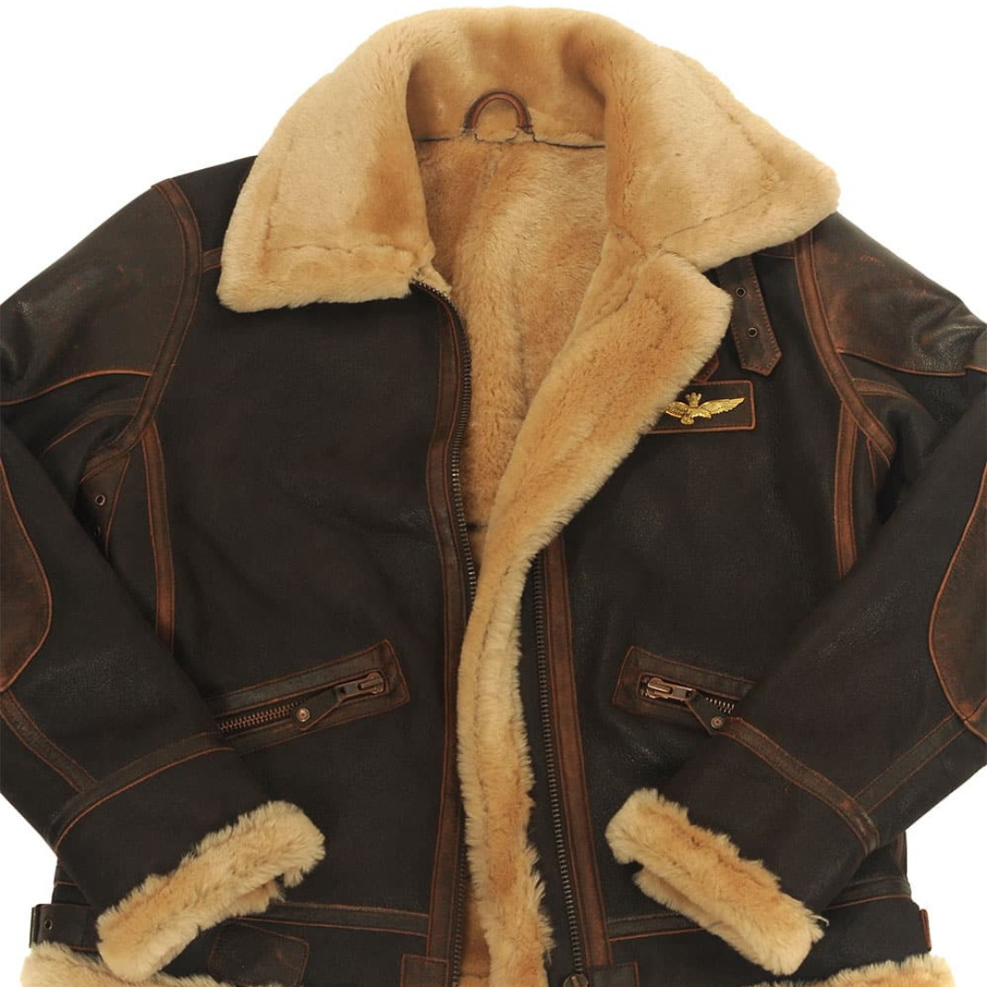 Open front view of pilot jacket revealing cream faux fur lining and gold badge
