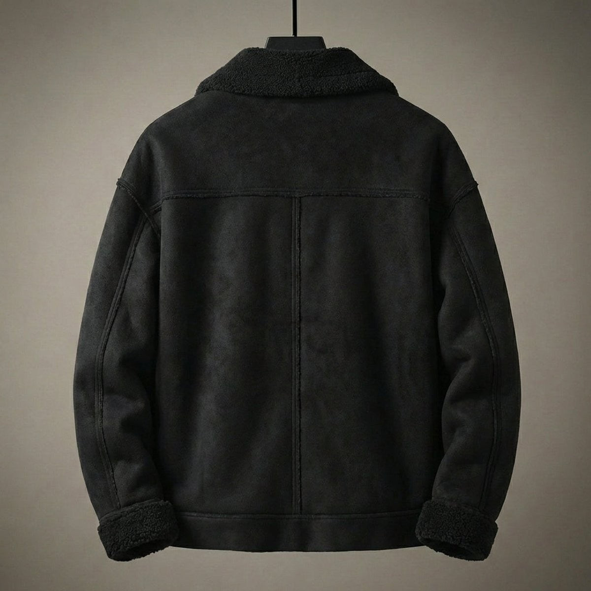 Rear view of black faux shearling aviator jacket showing seam detailing