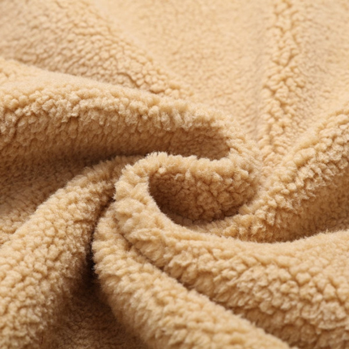 Close-up of soft beige sherpa fleece lining used in winter jacket