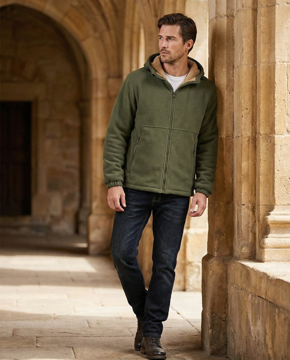 Man wearing khaki green fleece hoodie with sherpa lining, walking through stone archway