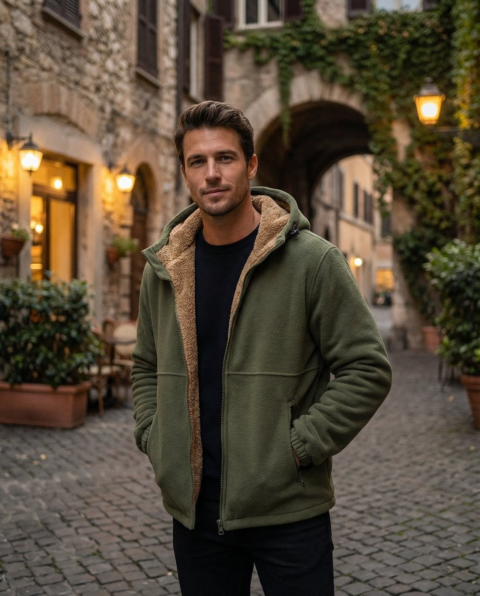 Man in cobbled courtyard wearing green fleece hoodie with cream sherpa-lined hood