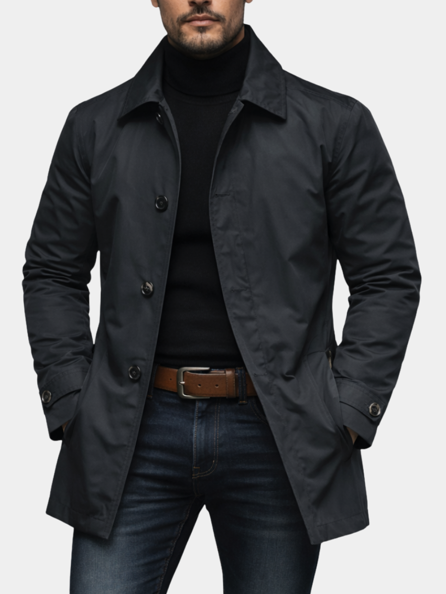 Black single-breasted mac coat worn with turtleneck jumper and jeans