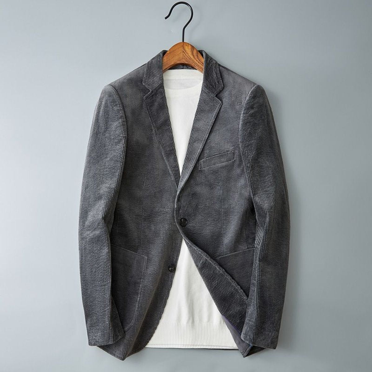 Grey corduroy tailored blazer with notched lapel, worn over a cream jumper