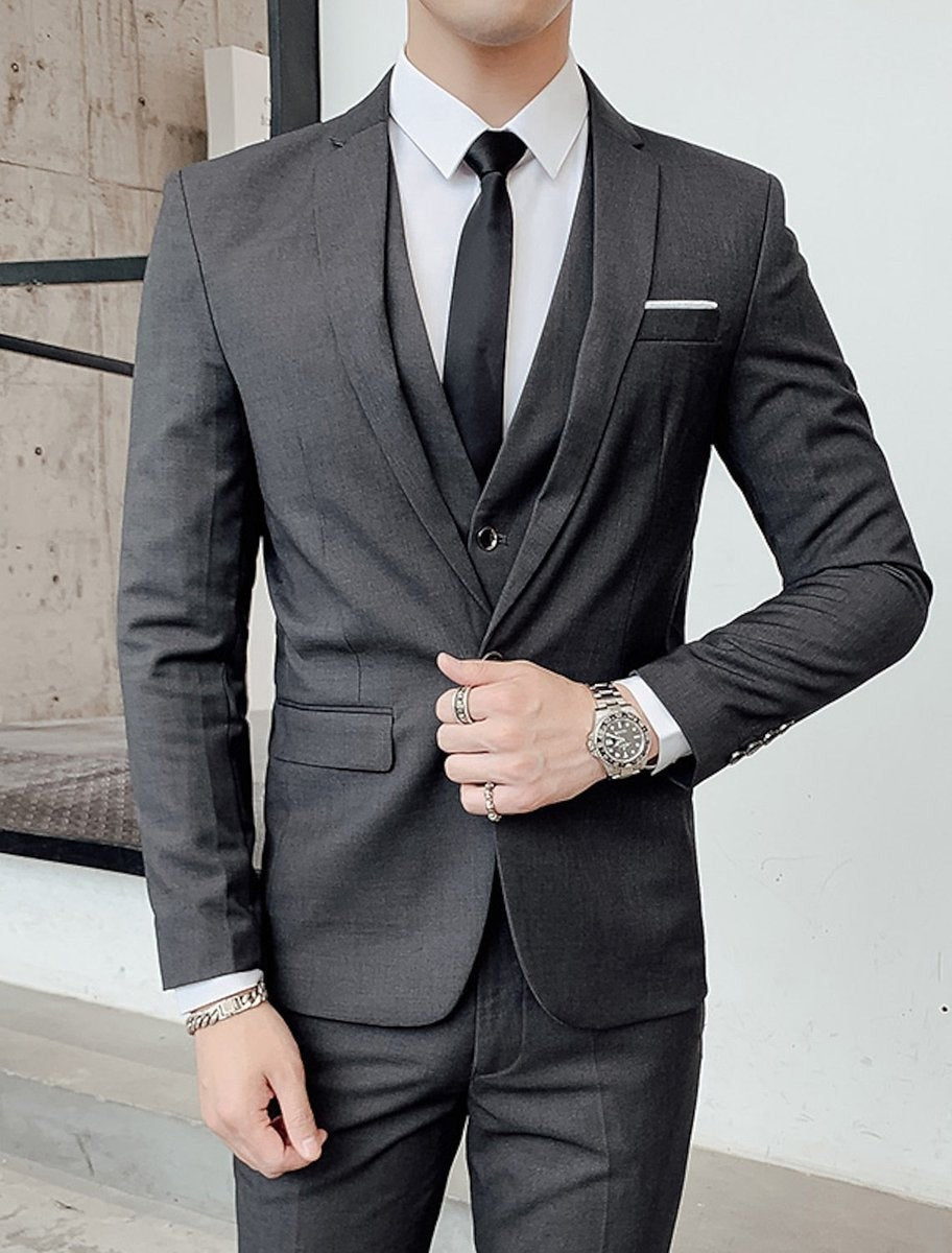 Charcoal grey tailored suit with matching waistcoat and black tie