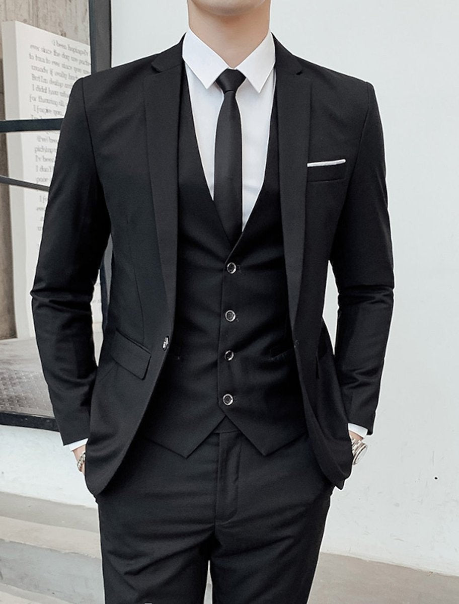 Black three-piece suit featuring satin lapel and buttoned waistcoat