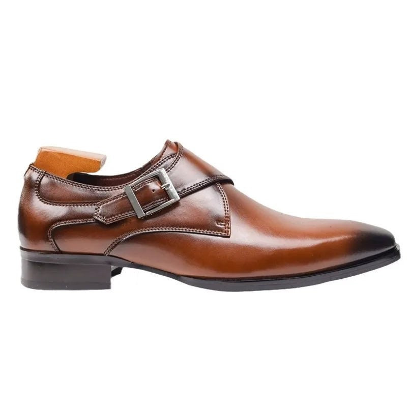 Side view of brown leather monk strap shoe showing buckle and stitched panels