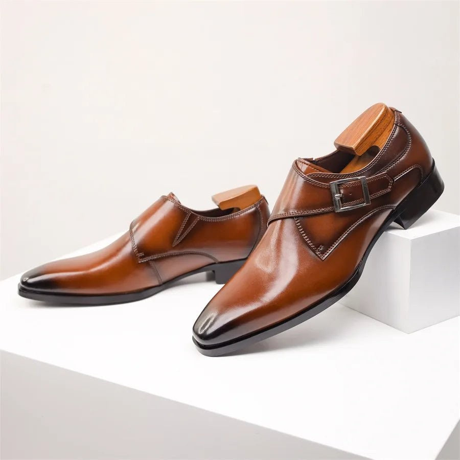 Angled view of brown leather single monk strap shoes with pointed toe