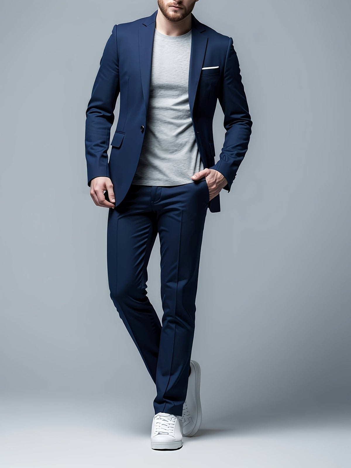 Navy blue skinny suit paired with a grey T-shirt and white trainers