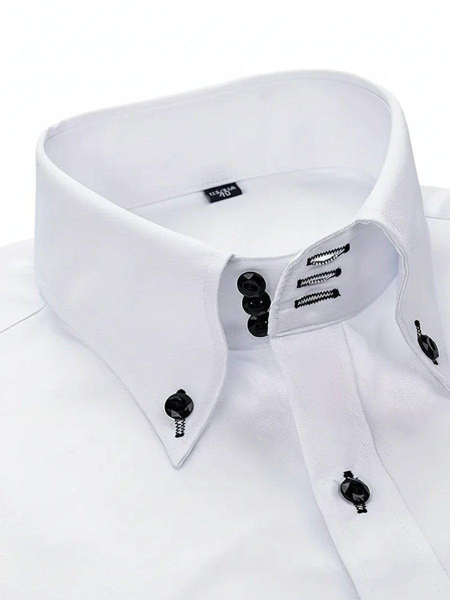 Close-up of white shirt collar showing triple black buttons and stitched trim