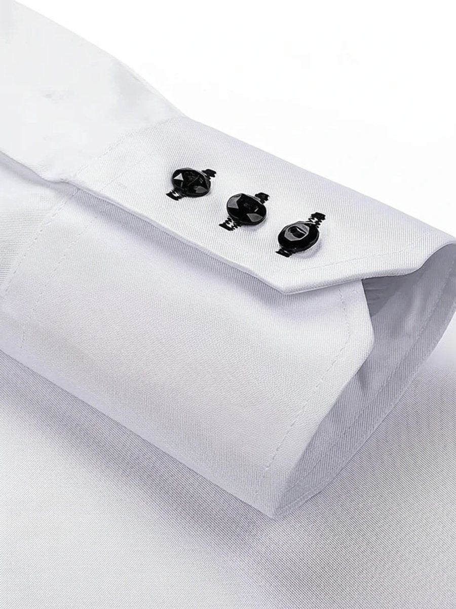 Detail of white shirt cuff featuring three decorative black buttons