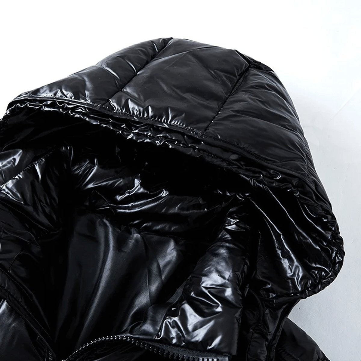 Close-up of hooded puffer jacket showing glossy fabric and drawstring toggle