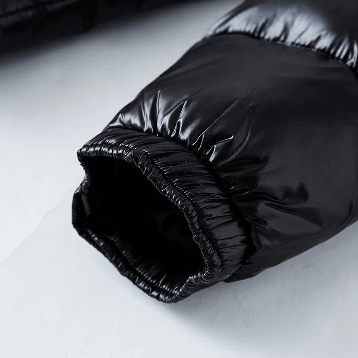 Elasticated cuff detail on black waterproof puffer jacket sleeve