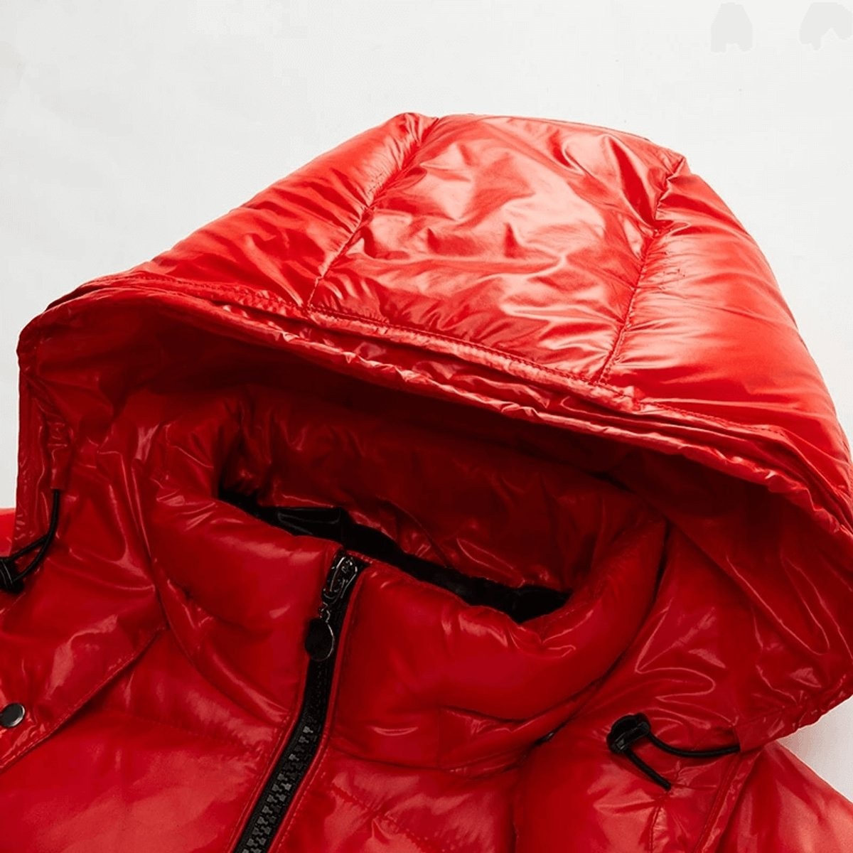 Close-up of red puffer jacket hood showing drawstring and glossy finish