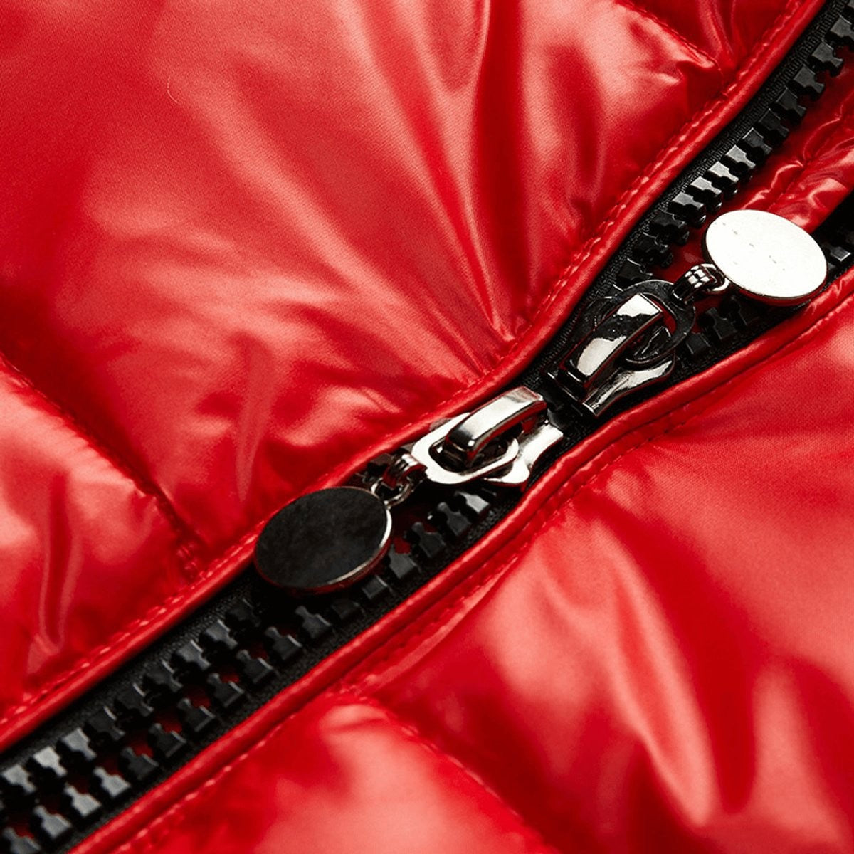 Zip pull close-up on red waterproof puffer jacket showing metal hardware