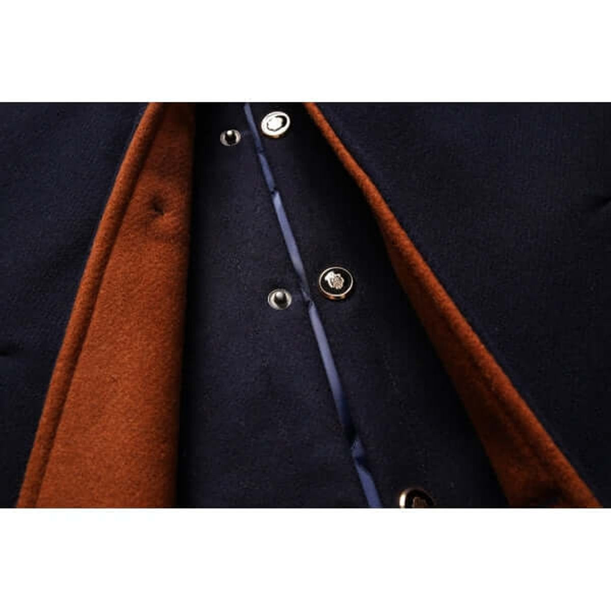 Close-up of navy overcoat placket showing dragon-embossed buttons