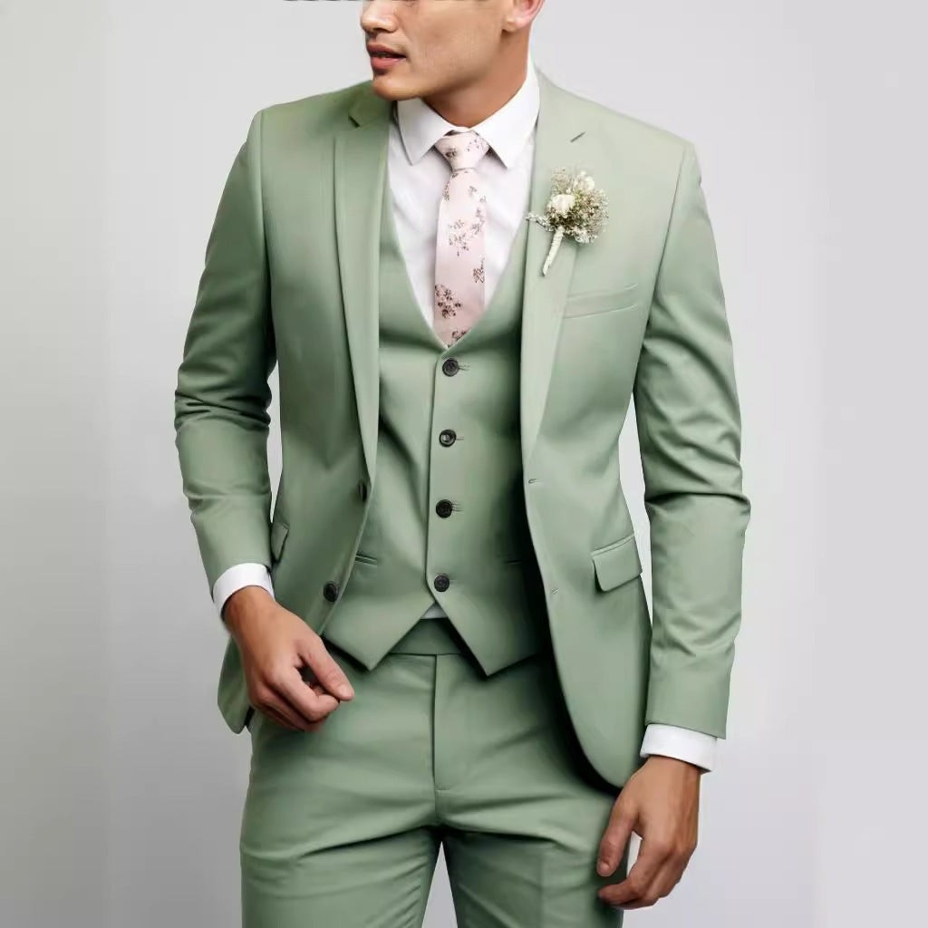 Sage green slim-fit three-piece suit styled with pink floral tie