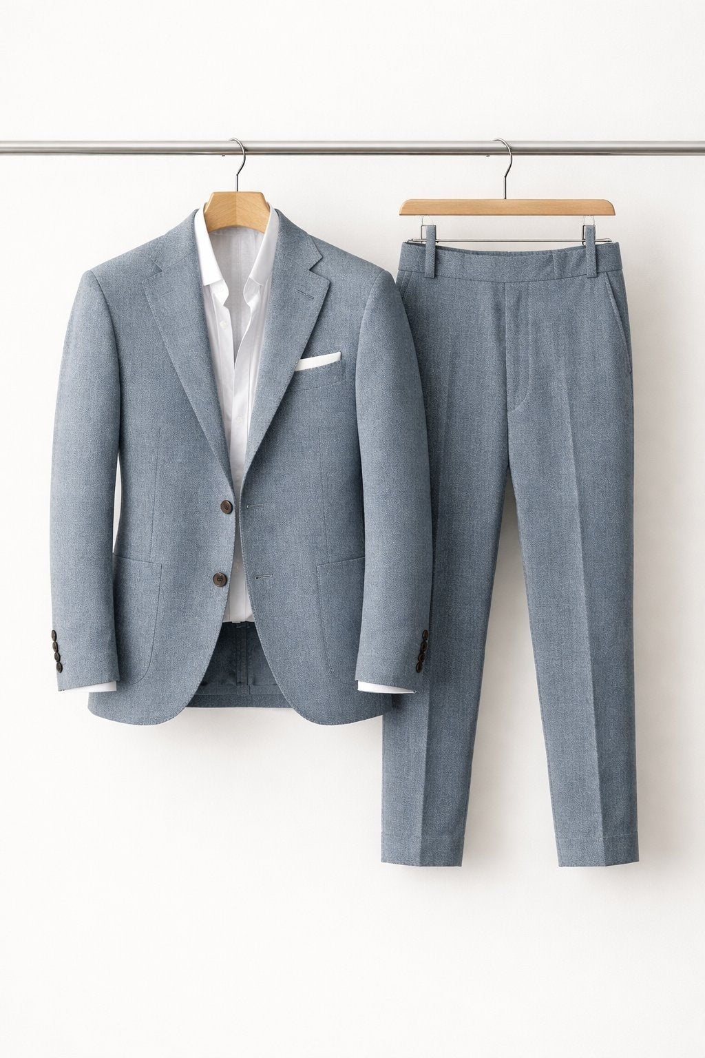 Pale blue textured suit jacket and trousers displayed on wooden hangers
