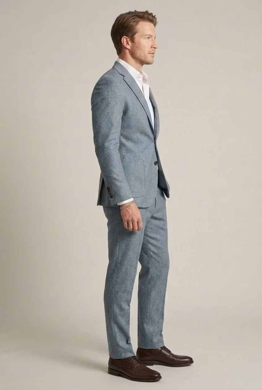 Side profile of pale blue slim-fit suit paired with brown Derby shoes