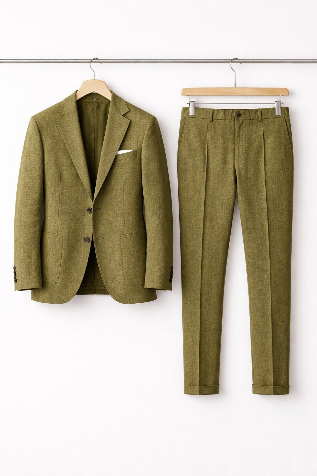 Olive green textured suit jacket with pleated trousers on wooden hangers