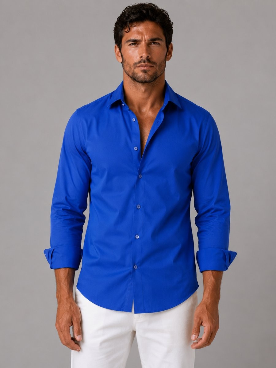 Cobalt blue slim-fit dress shirt with rolled cuffs and white trousers
