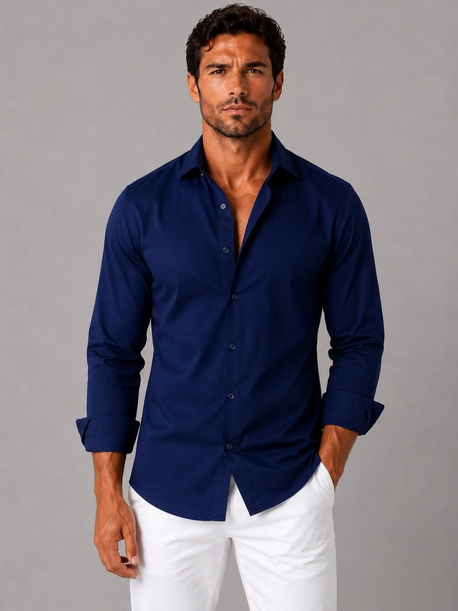 Navy slim-fit long-sleeve dress shirt worn open-collar with white chinos