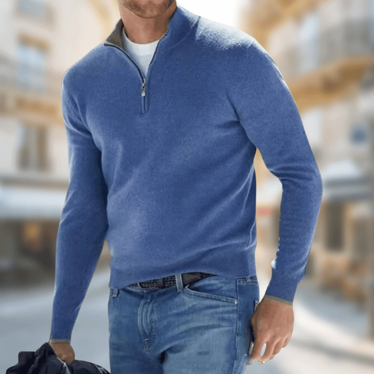 Blue quarter-zip knitted jumper worn with denim jeans for a casual look