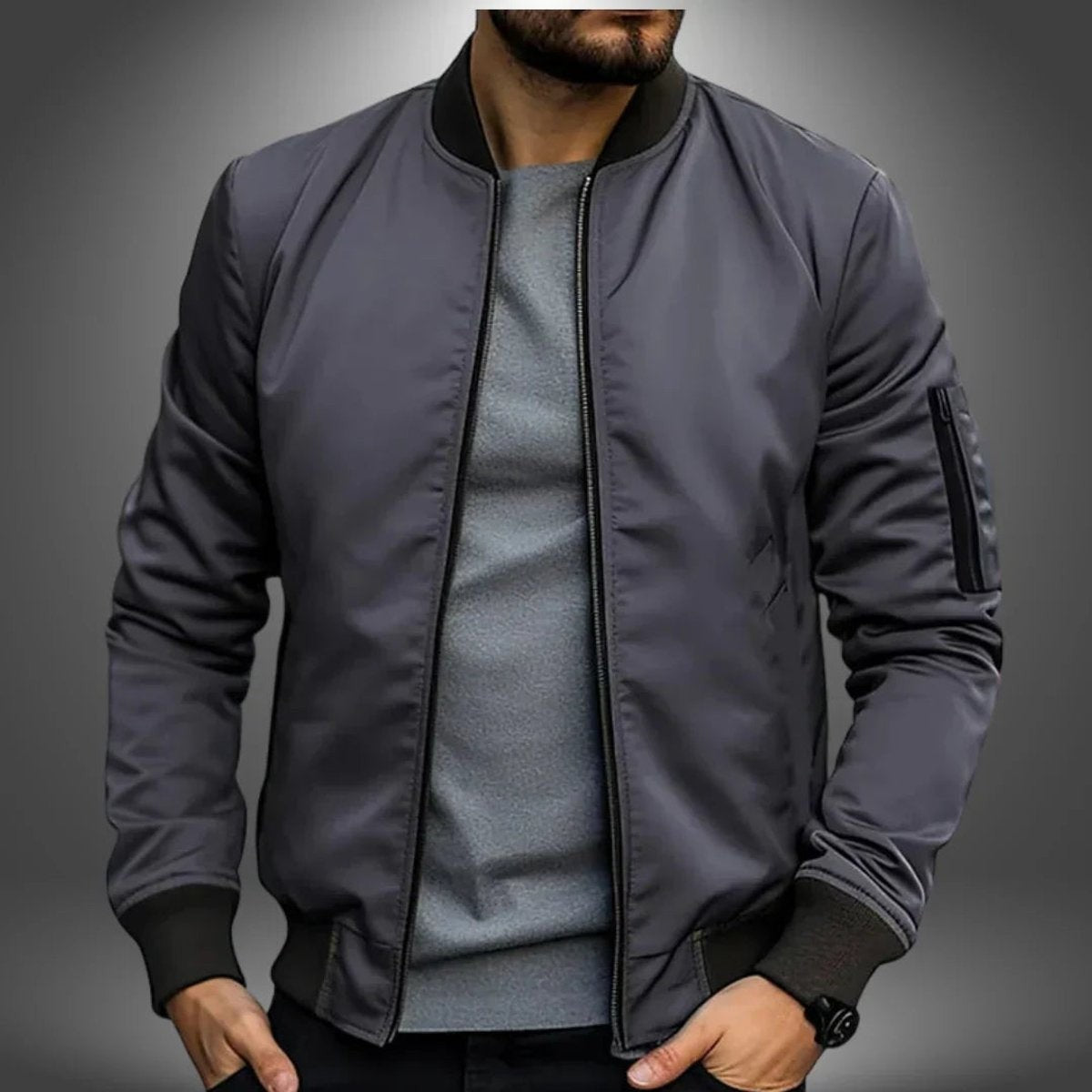 Charcoal grey bomber jacket featuring sleeve zip pocket and ribbed collar