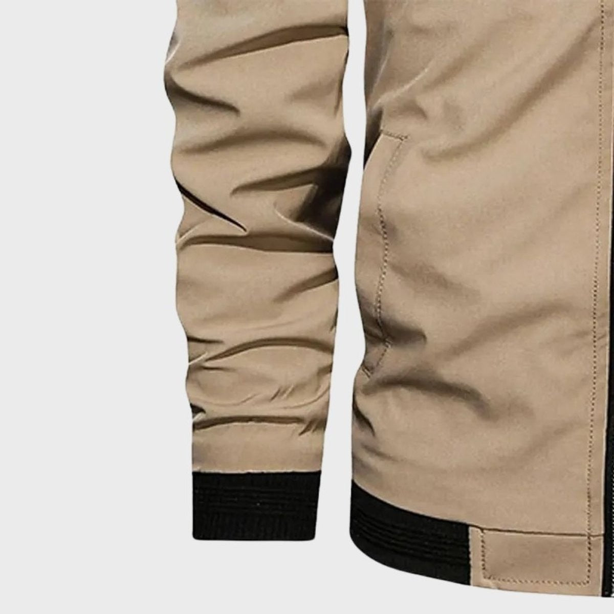 Close-up of beige bomber jacket sleeve and ribbed cuff detail