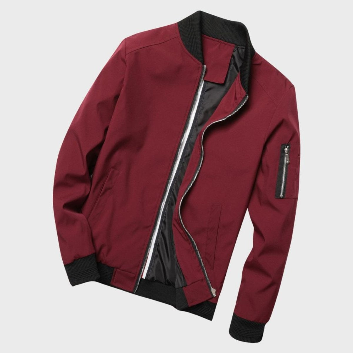 Burgundy bomber jacket with black ribbed collar and striped zip
