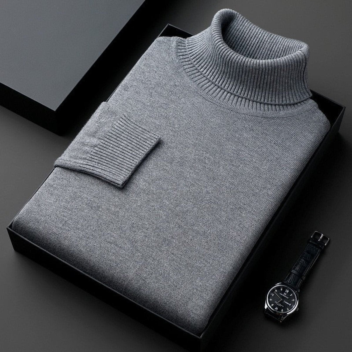 Grey ribbed turtleneck jumper folded neatly in a black gift box