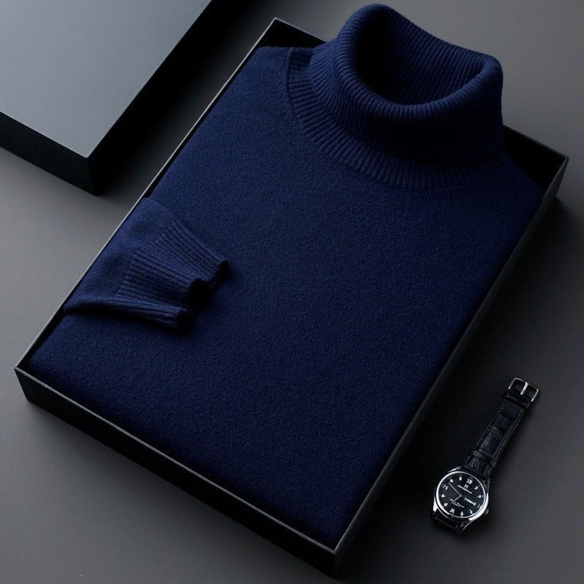 Navy cashmere turtleneck jumper folded with ribbed cuffs and high collar