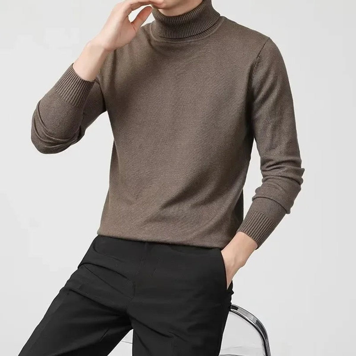 Taupe knitted turtleneck jumper styled with black tailored trousers