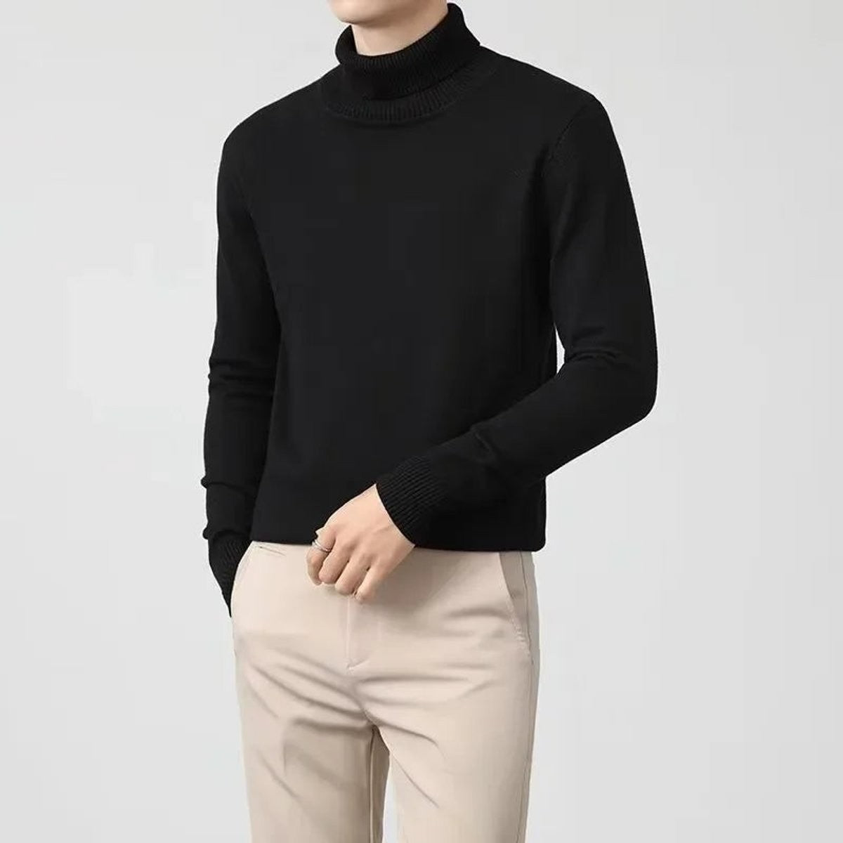 Black cashmere roll-neck jumper worn with beige tailored trousers, slim fit