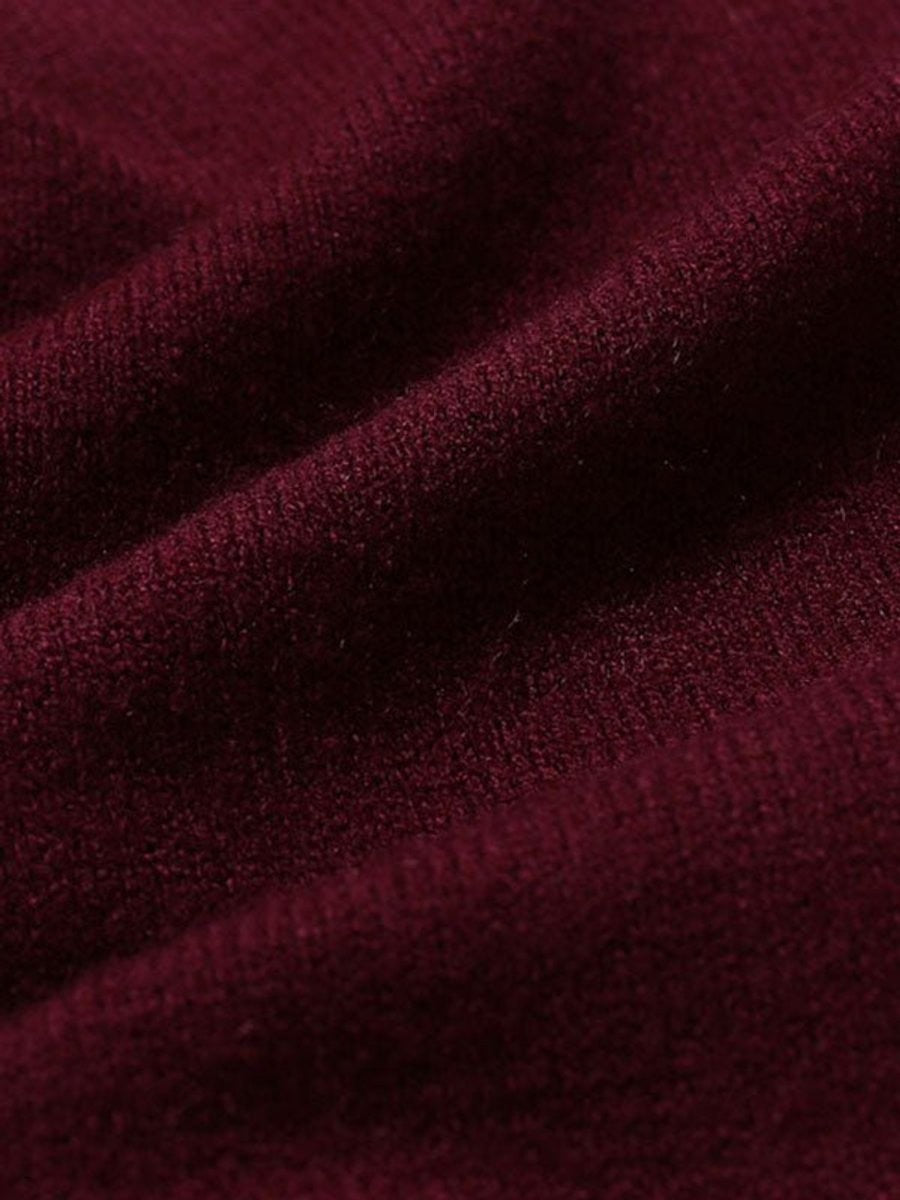 Close-up of burgundy knit fabric texture on slim-fit jumper
