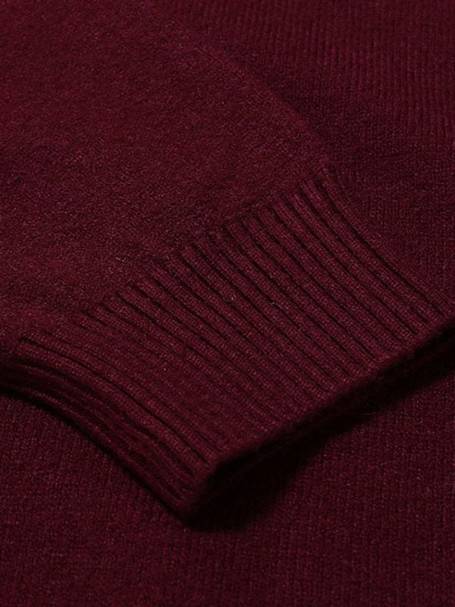 Close-up of ribbed cuff detail on burgundy knitted turtleneck jumper