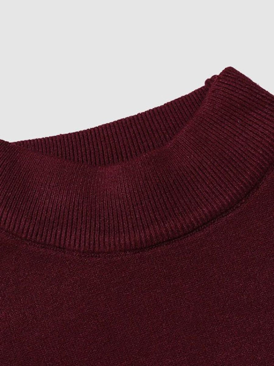 Close-up of burgundy ribbed turtleneck collar on knitted jumper