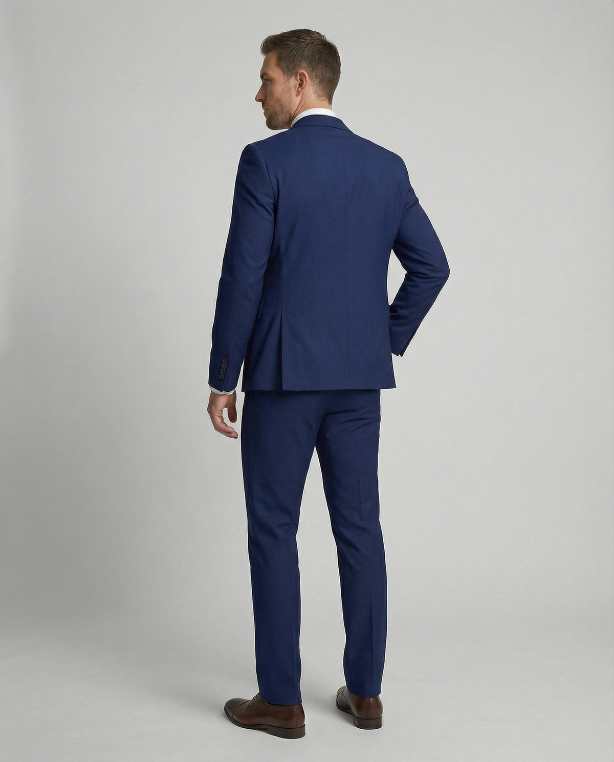 Rear view of navy three-piece suit showing tailored jacket and trousers