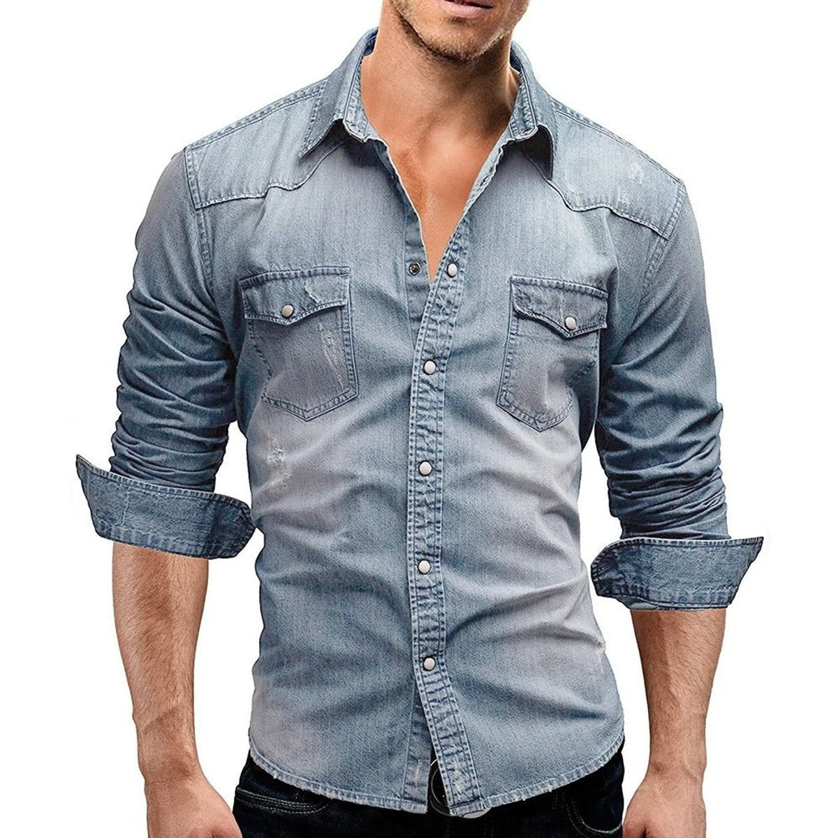 Man wearing light blue distressed denim shirt with twin chest pockets and rolled sleeves