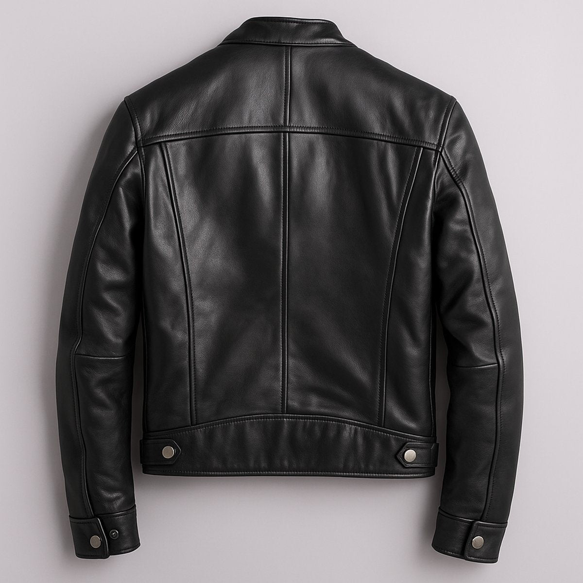 Rear view of black leather biker jacket showing seam detailing and cuffs
