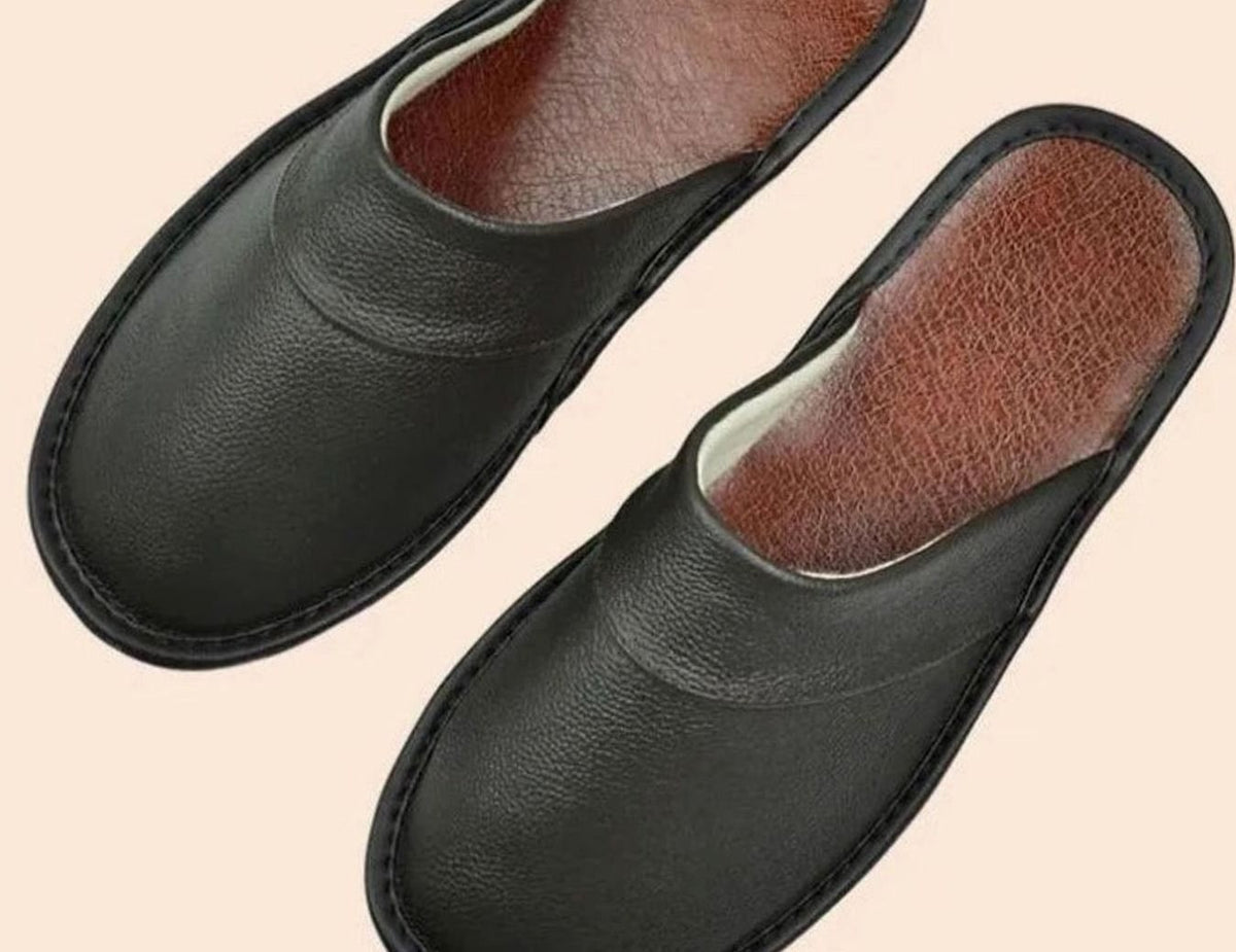 Black leather slip-on slippers with tan leather insole
