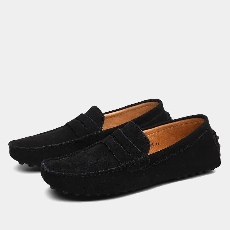 Black suede penny loafers with tan leather lining and driving sole