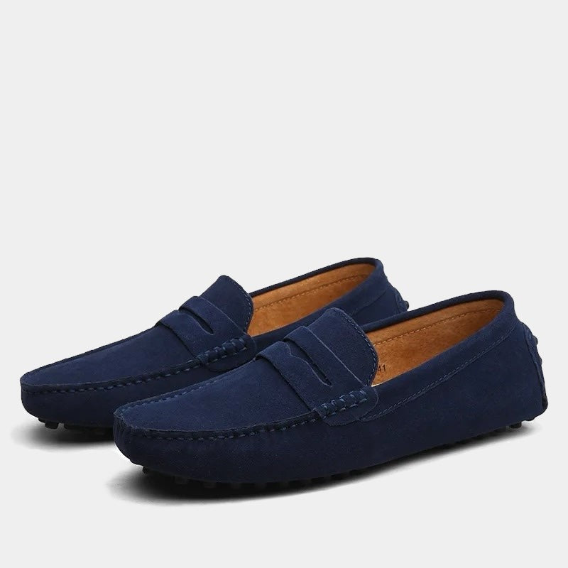 Navy suede driving loafers with tan insole and studded sole