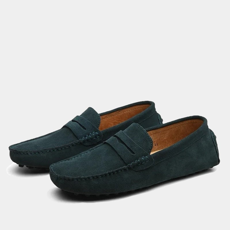 Deep teal suede penny loafers with tan leather lining and moccasin toe